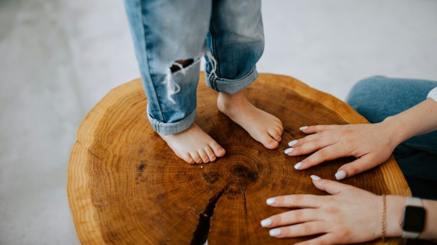 a person standing on top of a wooden table